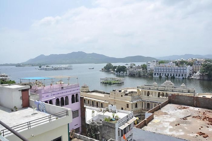 Lake Pichola and the Lake Palace seen across the rooftops of the old city from the hotel terrace
