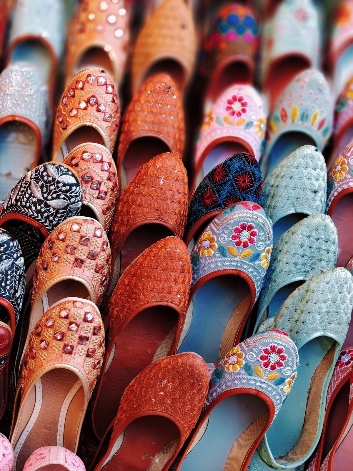 Rows of embroidered leather juttis for sale in an Udaipur bazaar